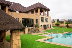 a house with a swimming pool in the yard at Bishop's Manor Luxurious Retreat in Muldersdrift