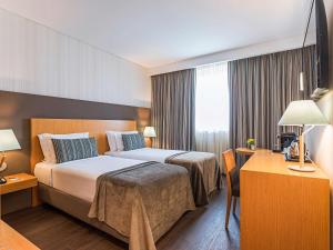 Ein Bett oder Betten in einem Zimmer der Unterkunft Mercure Lisboa Almada