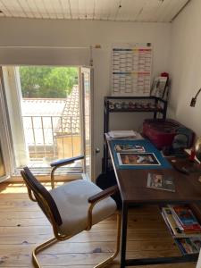 a room with a desk and a table with chairs at Appartement du sud in Saint-André-de-Sangonis +8 photos
