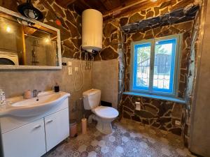 a bathroom with a sink and a toilet and a window at Zázrak in Banská Štiavnica +10 photos