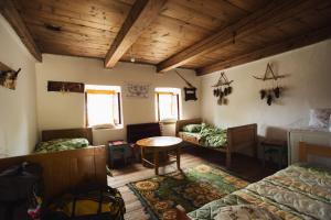 a room with two beds and a table in it at Household Šain in Pluzine