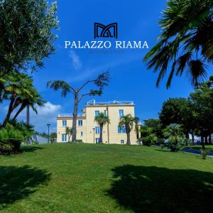 a house in a park with palm trees at RIAMA AGRIRESORT in Naples