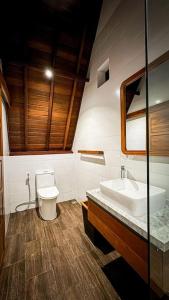 a bathroom with a toilet and a sink at Villa Tegal lovina in Buleleng