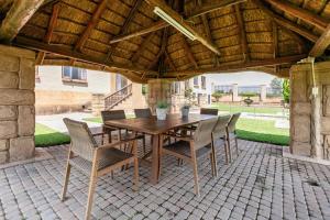 a wooden table and chairs on a patio at Bishop's Manor Luxurious Retreat in Muldersdrift