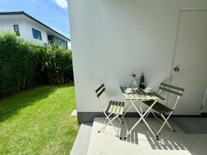 a table and chairs sitting on a patio at Garden Room with Private Entrance in Luxury Residence in Bangkok