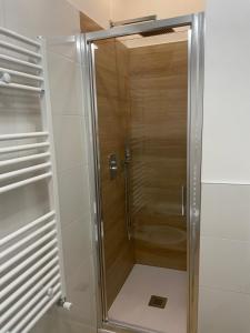 a shower with a glass door in a bathroom at Real home in Azzano San Paolo