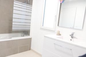 a bathroom with a sink and a tub and a mirror at La maison de Qui miac in Quimiac +23 photos