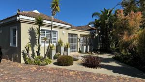 a house with a lot of plants in front of it at Plett57 - Self Catering - Room No2 in Plettenberg Bay