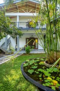 a koi pond in front of a house at 18 Villa in Hikkaduwa