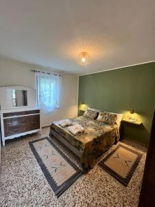 a bedroom with a large bed and a television at Bardi al Riolo Olivo appt in Bardi