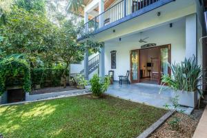 an exterior view of a house with a yard at 18 Villa in Hikkaduwa