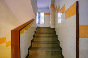 a staircase in a prison cell with a stair case at Via Manas Residency in Mumbai