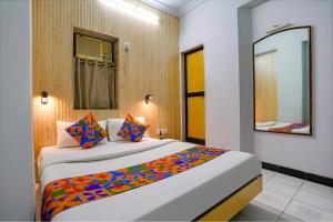 a bedroom with a large bed with a mirror at Via Manas Residency in Mumbai +24 photos
