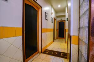 a hallway with two doors and a tile floor at Via Manas Residency in Mumbai