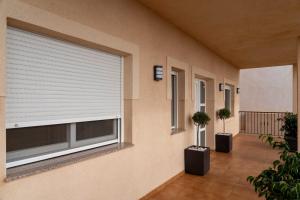 a room with a window and two potted plants at Villa Cruceiro in Los Belones
