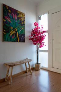 a bench and a tree in a room with a painting at Villa Cruceiro in Los Belones +51 photos