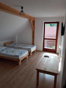 a room with two beds and a window at Agroturystyka Izby in Izby