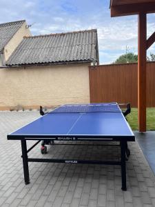 a blue ping pong table sitting on a patio at Ikervár-lak in Ikervár +24 photos