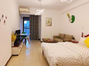 a bedroom with a bed and a living room at YoYo Youth Apartment in Guangzhou