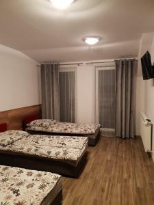 Ένα ή περισσότερα κρεβάτια σε δωμάτιο στο Noclegi u Reni