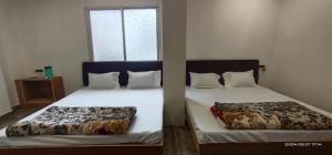 Postel nebo postele na pokoji v ubytování Hotel nandmani