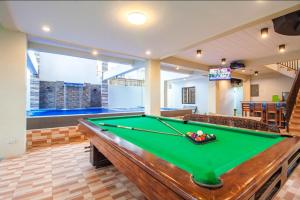 a pool table in a living room with a pool table at Casa Florida Private Resort - Calamba in Calamba