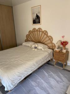 a bedroom with a bed with a wooden headboard at Appartement du sud in Saint-André-de-Sangonis