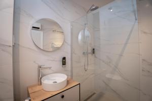 a white bathroom with a sink and a shower at Villa Malo More in Trogir +29 photos