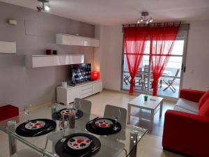 a living room with a glass table with plates on it at Perla del mar in Moncófar