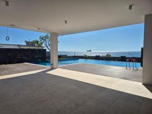 a swimming pool with a view of the ocean at Sweet Berry in Port Louis