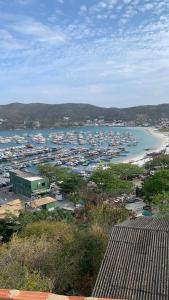 a view of a harbor with boats in the water at Casa incrível praia dos anjos in Arraial do Cabo