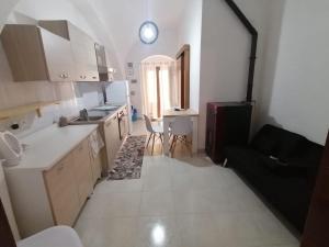 a kitchen with a sink and a table in it at Appartamento 24 letti con cucina e parcheggio privato gratuito in Candela +64 photos