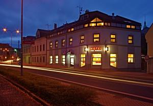 a building on the side of a street at night at Hotel Pod Radnicí in Šumperk