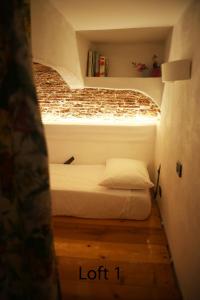ein kleines Schlafzimmer mit einem Bett in einem kleinen Zimmer in der Unterkunft Loft in San Lorenzo in Genua