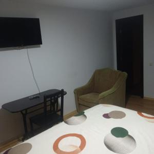 a room with a bed and a table and a tv at Nord Accomodation in Bucharest
