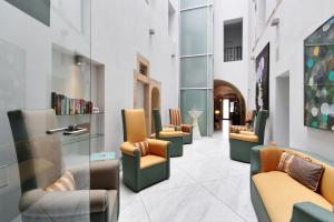 a waiting room with chairs and books on the wall at SKARITZ Hotel & Residence in Bratislava