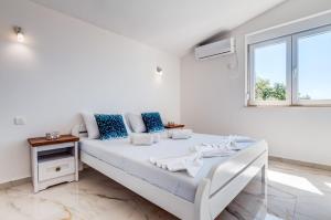 Postel nebo postele na pokoji v ubytování Villa Hanna Apartments