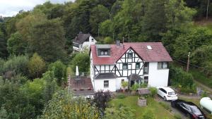 an aerial view of a white and black house at Ferienwohnung Schäfer in Waldbreitbach