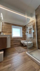 a bathroom with two sinks and a glass shower at CASA MIRO' vicinissima al mare e parcheggio privato gratuito se disponibile in Pescara +48 photos