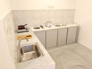 a small kitchen with a sink and a stove at Coastal Dreams in Weligama