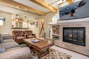 a living room with a couch and a fireplace at Vail Antlers 2 Bedroom Condo in Vail