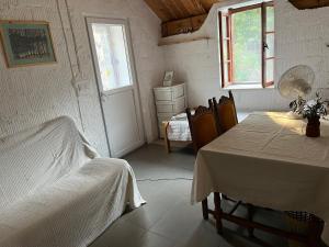 a white room with a table and a bed in it at Artist's House on the Mountain in Zelenika