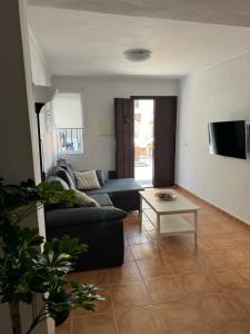 a living room with a couch and a table at Casa Cuevas del Sol in Setenil