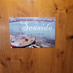 a sign on a wooden door with a boat in the water at Kings River Reflections in Sanger