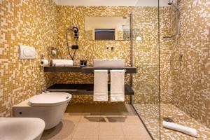 a bathroom with a toilet and a sink and a shower at Phi Hotel Piajo in Nembro +62 photos