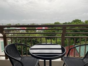 a table and four chairs on a balcony at Eves Urban Haven in Manila