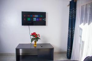 a room with a table with a vase of flowers on it at Joe's hub in Bungoma