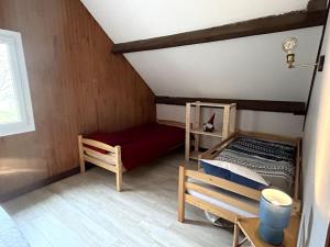 a room with a bed and a bench in a room at Chalet de montagnes in Campan +3 photos