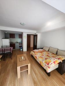 a bedroom with a bed and a table in a room at Apartment Joco in Ohrid