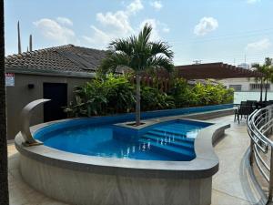 a swimming pool in front of a house at Piloes Palace Hotel in Mineiros